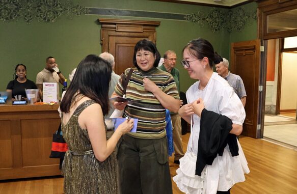 Claire Huangci, pianist, signs CDs at reception {{brizy_dc_image_alt imageSrc=