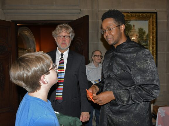 Xak Bjerken & Steven Banks talk to a young fan.